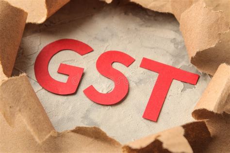 Gst Word And Torn Paper And Magnifier Taxes On The Background Of Craft