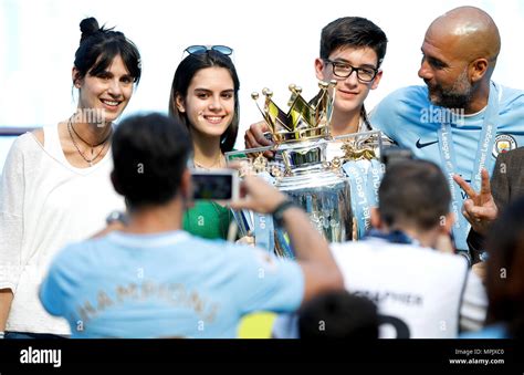 Pep Guardiola (right) celebrates with the trophy and wife Cristina Serra (left) and family Stock ...