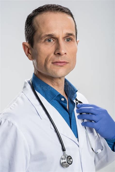 Pensive Appealing Male Physician Waiting For Patient Stock Image