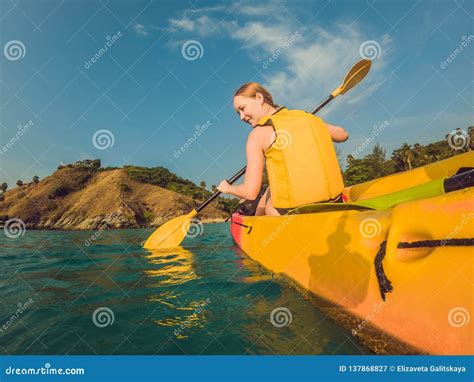 Smiling Young Woman Kayaking On Sea Happy Young Woman Canoeing In Sea