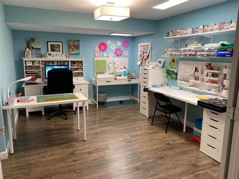 a room with two desks and several shelves