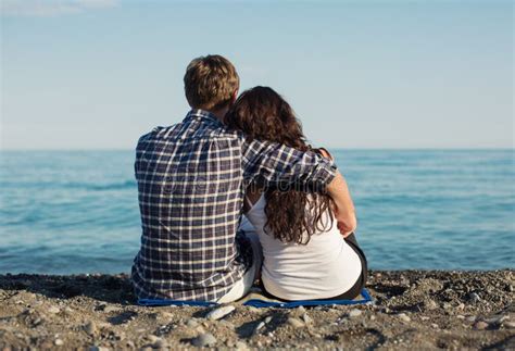 Couple Hugging Sitting On The Sand Of The Beach Stock Image Image Of