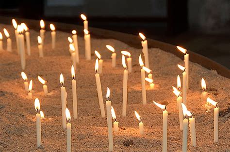 Royalty-Free photo: Lighted white candle sticks on white sand | PickPik