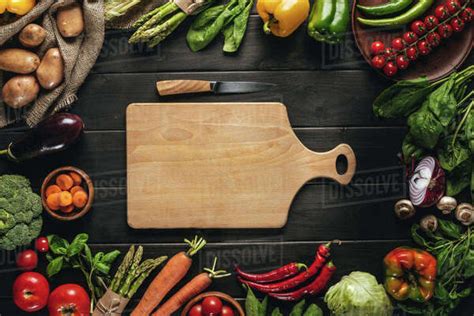 Top View Of Cutting Board With Knife And Organic Fresh Vegetables