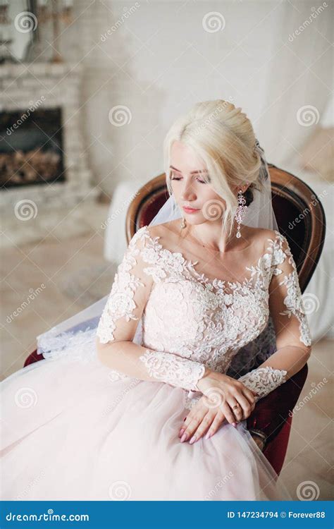 Beautiful Blonde Bride In White Dress In The Boudoir Stock Photo