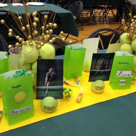 There Are Tennis Balls On The Table With Cards And Photos In Them