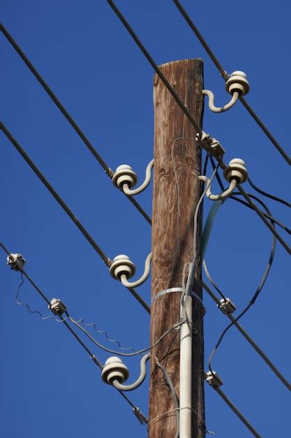 Premium Photo Low Angle View Of Telephone Pole Against Blue Sky