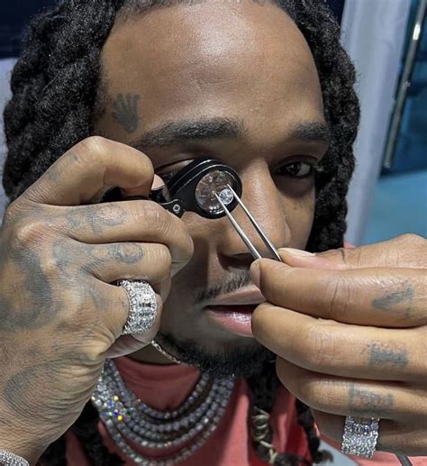 A Man With Dreadlocks Is Looking Through A Magnifying Glass And Has