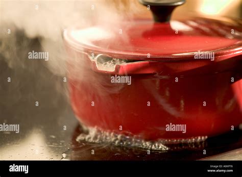 Red Saucepan On Cooker Boiling Over Stock Photo Alamy