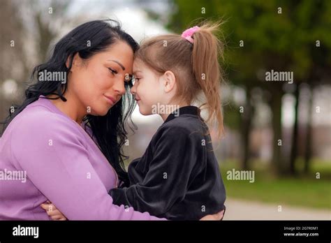 One Lonely Upset Mother Touching With Foreheads With Daughter At