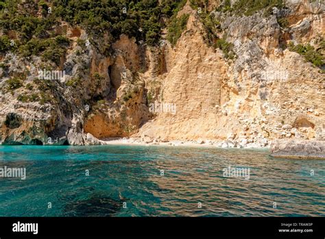 Cala Dei Gabbiani A Narrow Sandy Beach Below High Limestone Cliffs