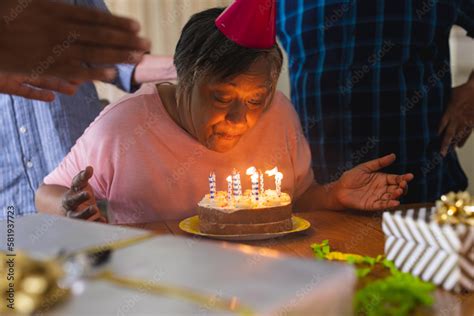 Happy Group Of Diverse Senior Friends Celebrating Birthday With Cake