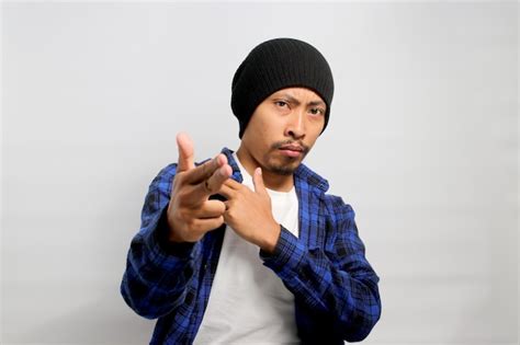 Premium Photo Asian Man Points Around With A Finger Gun Gesture