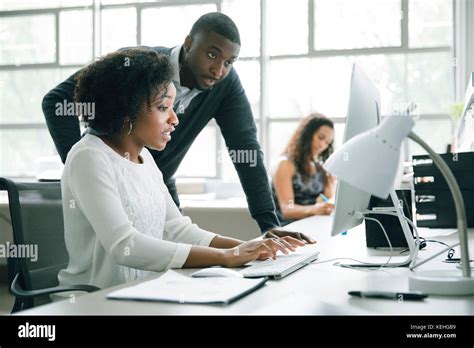 Business people using computer in office Stock Photo - Alamy