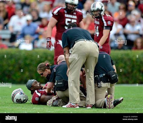 South Carolina Running Back Marcus Lattimore Is Comforted By A Trainer