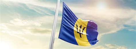 Premium Ai Image Barbados National Flag Waving In Beautiful Sky