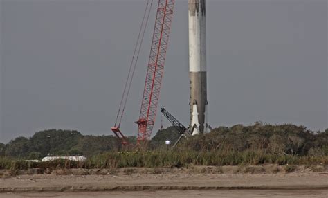 Photos: Falcon 9 booster stands upright after landing – Spaceflight Now