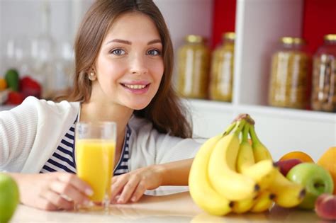 Premium Photo Portrait Of A Pretty Woman Holding Glass With Tasty Juice