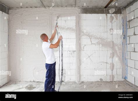 Worker Plasterer Plastering House Walls Finishing Walls With Spray