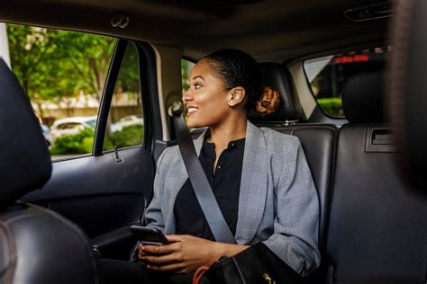 Contemplative Businesswoman Looking Through Window Sitting In Car