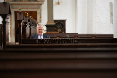 He Spends A Lot Of Time In Church A Senior Man Sitting In The Pews At