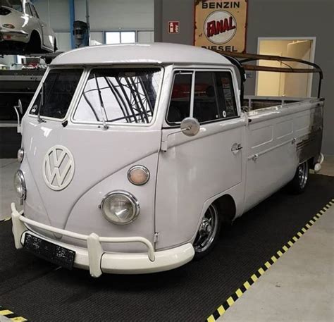 An Old Vw Bus Is Parked In A Garage