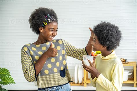 Two cute adorable siblings african american children having breakfast ...