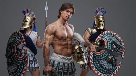 Muscular Greek Swordsman With Naked Torso And Two Comrades Stock Photo