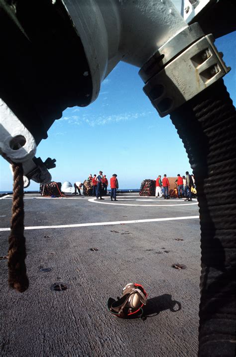 Crew Members Aboard The Guided Missile Cruiser Uss Belknap Cg 26 Stand By To Help Move Boxes