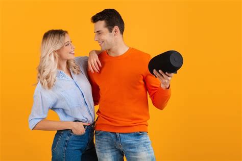 Free Photo Beautiful Smiling Young Couple Holding Wireless Speaker