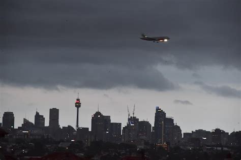 Premium Photo Airplane Flying Over Buildings In City Against Sky