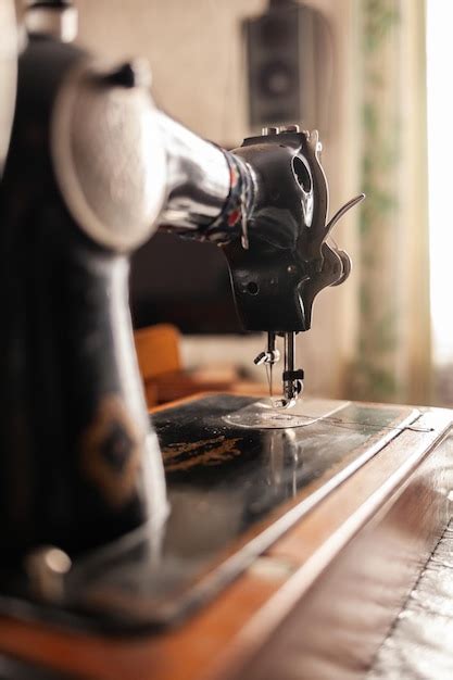 Premium Photo An Old Sewing Machine Stands On The Table At Home Ready