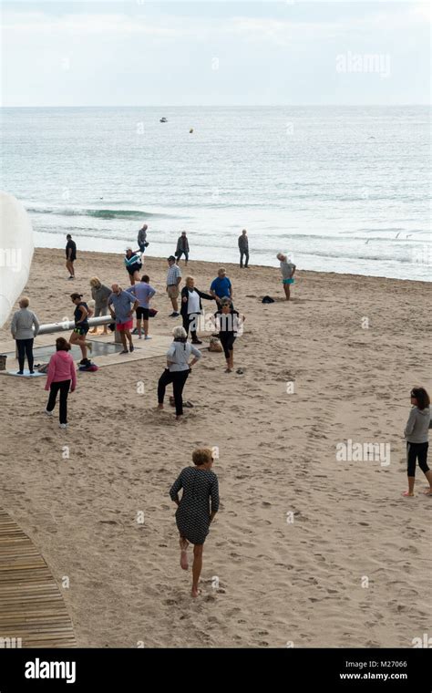 Seniors keeping fit on the beach in Benidorm, Spain. Men women oap's, elderly fitness class ...