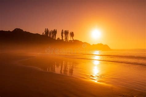 Bright Sunrise With Ocean Waves And Rocks With Trees Joaquina Beach In