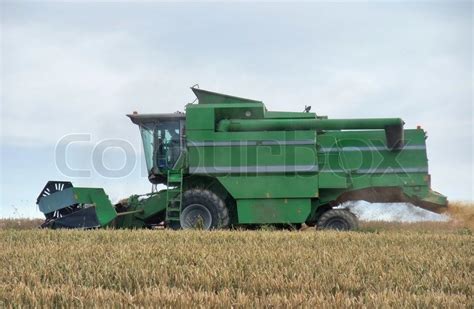 Harvesting harvester on a crop field | Stock image | Colourbox