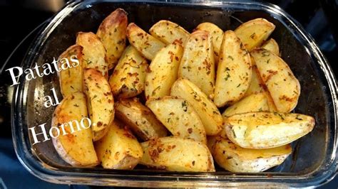 Potatoes In A Glass Dish With The Words Patatas Al Hormo