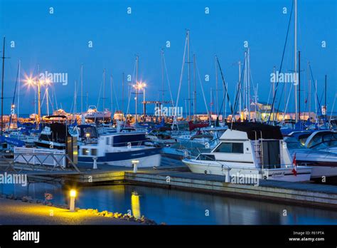 Yachts At The Bronte Outer Harbour Marina At Dusk During A Full Moon