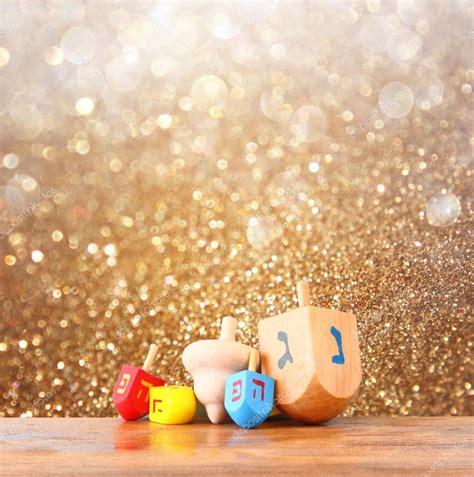 Wooden Dreidels For Hanukkah And Glitter Golden Lights Background