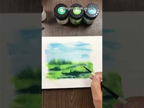 Someone Is Painting Some Green And Blue Watercolors