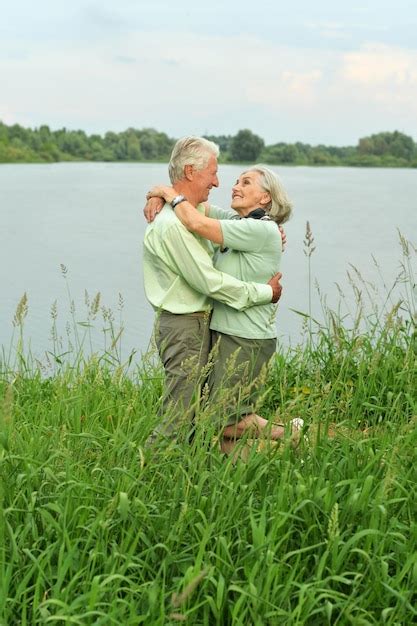 Premium Photo Loving Mature Couple Near Lake In Summer