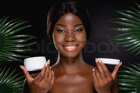 African American Naked Woman With Cosmetic Cream Near Green Palm Leaves