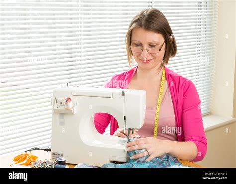 Woman Using A Sewing Machine Stock Photo Alamy