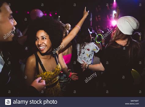 Smiling Young Female Millennial Dancing And Partying In Nightclub Stock