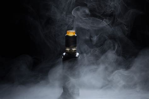 Premium Photo | Vape close-up in a smoke on a black background