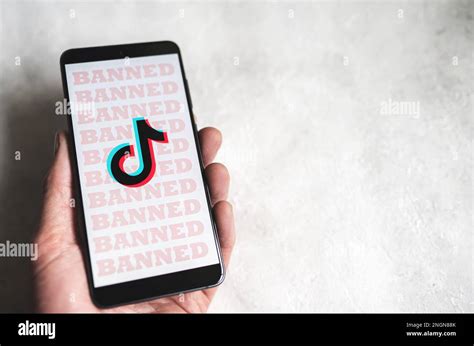 Tiktok App Logo With Banned Sign On Phone Screen In Hand Tik Tok Ban