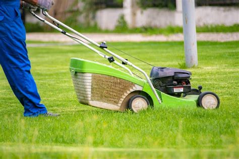 Gardener Worker Cutting Grass With Mower In The Backyard Lawn Fields Stock Image Image Of