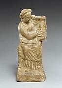 Fragmentary Terracotta Statuette Of A Woman With A Kithara Greek