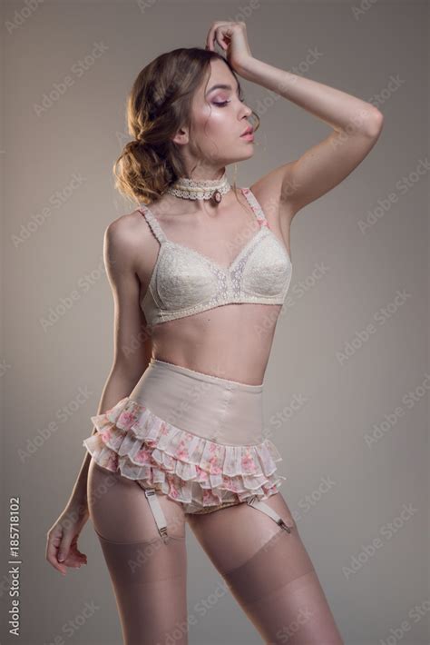 Lady In White Vintage Retro Lingerie Posing At Camera Stock Photo