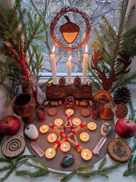 A Table Topped With Lots Of Candles And Other Items Next To A Window Sill