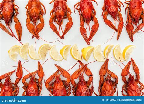 Top View Of Red Lobsters And Lemon Slices On White Background Stock